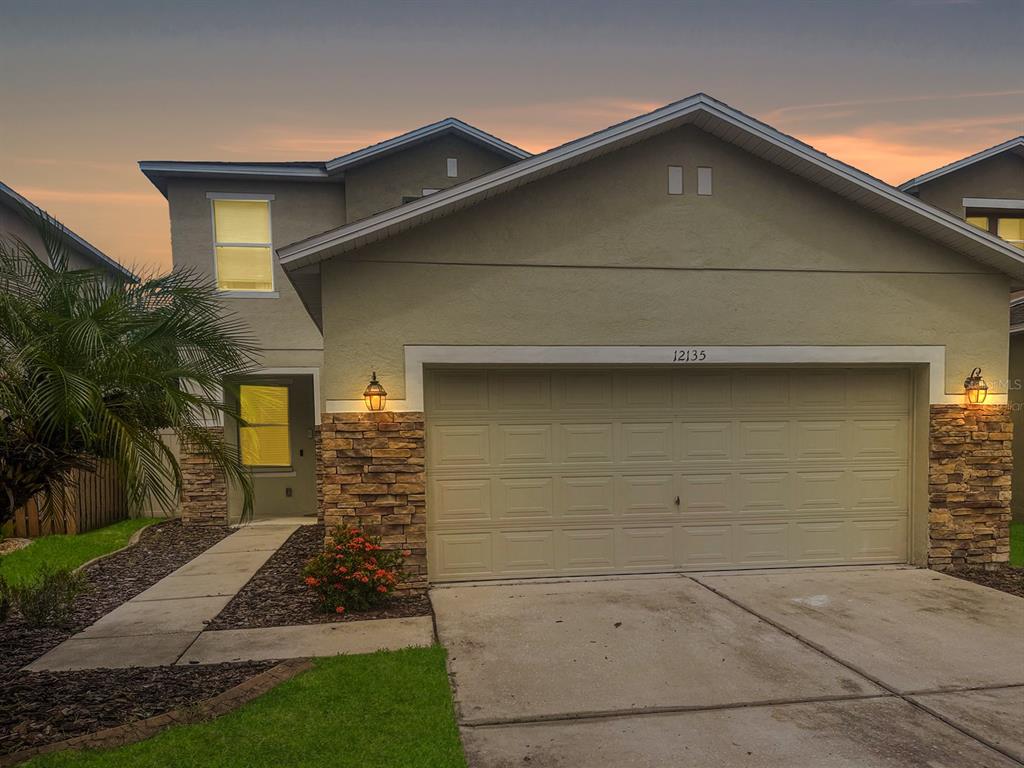 a front view of a house with garage