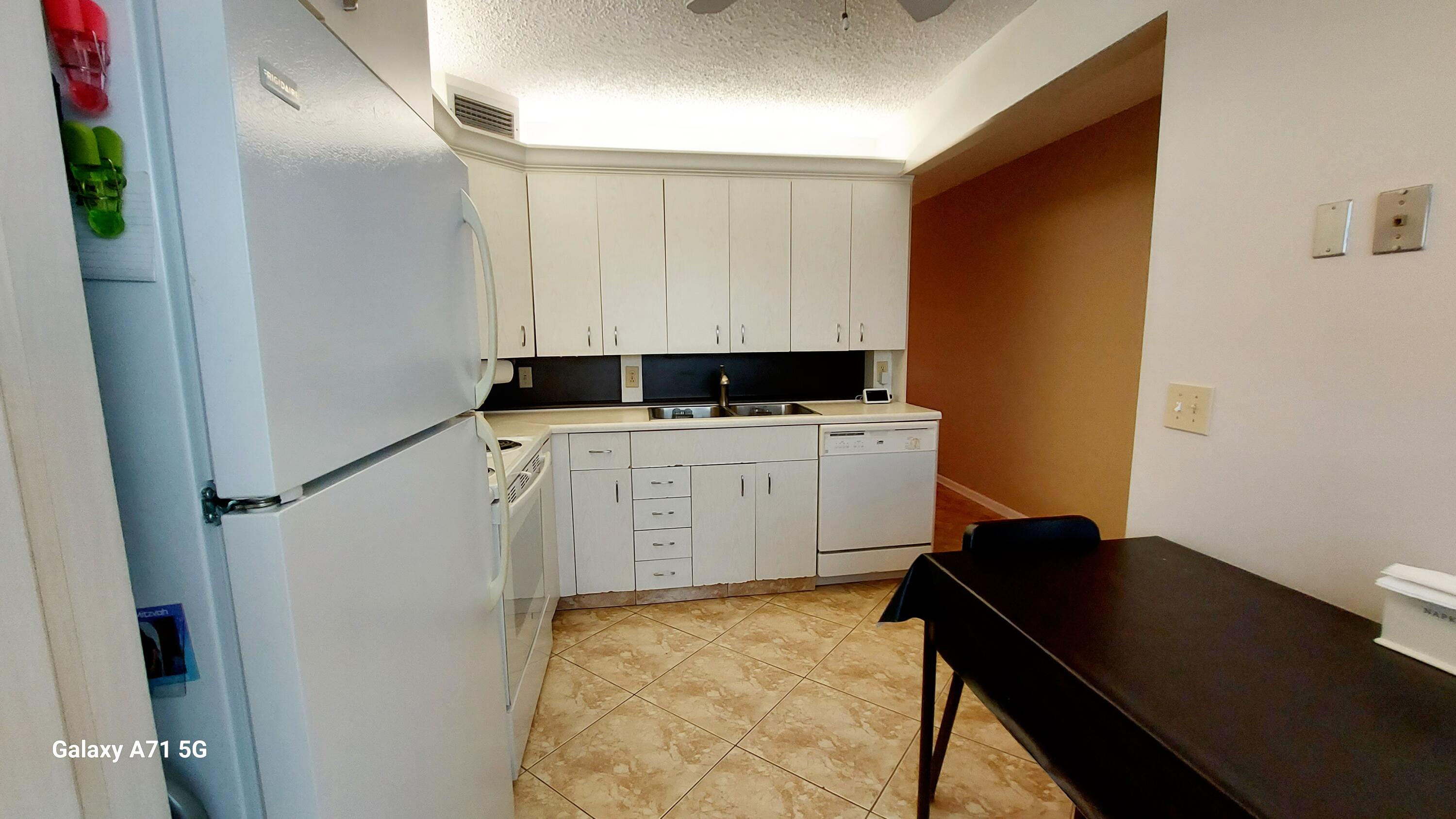 a utility room with sink dryer and washer