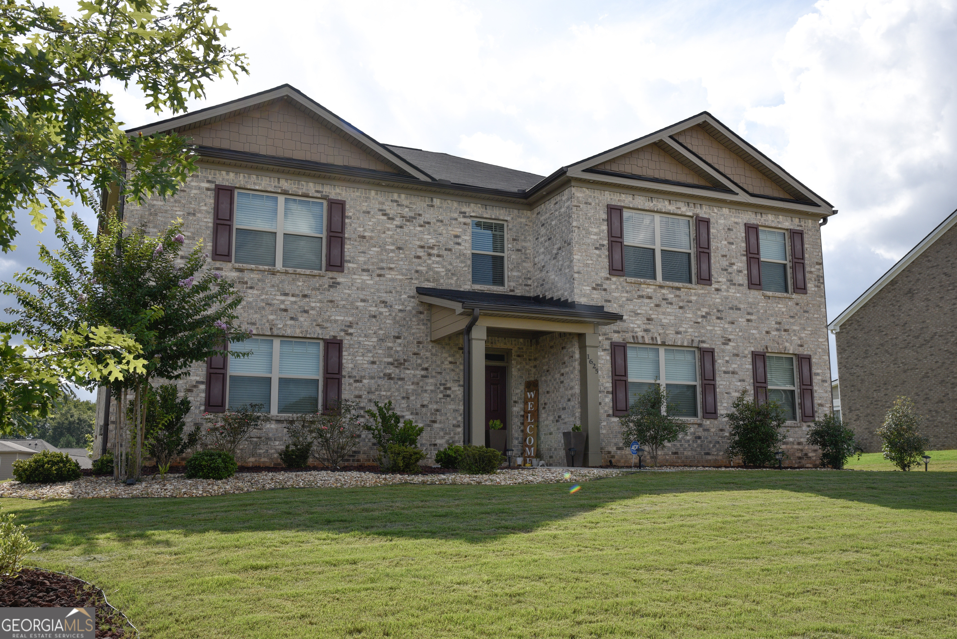 a front view of a house with a yard