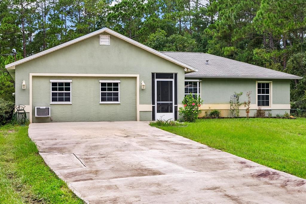 a front view of house with yard and green space