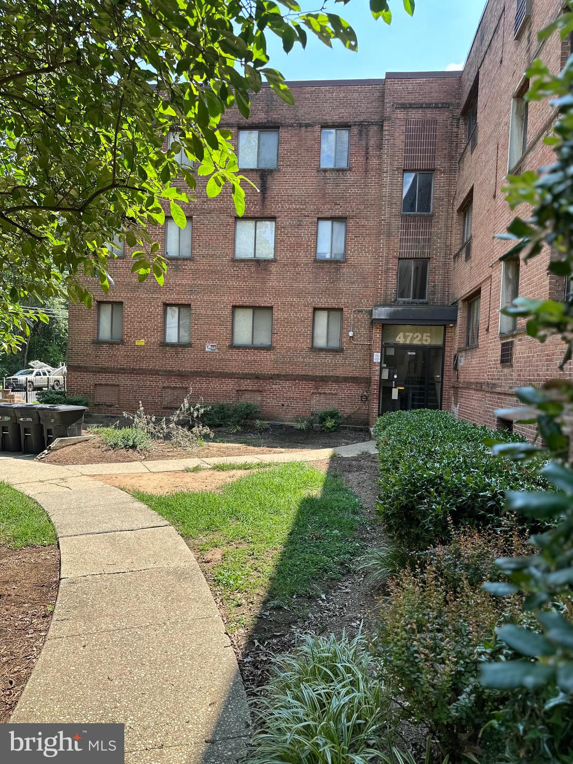 a view of a brick building next to a yard