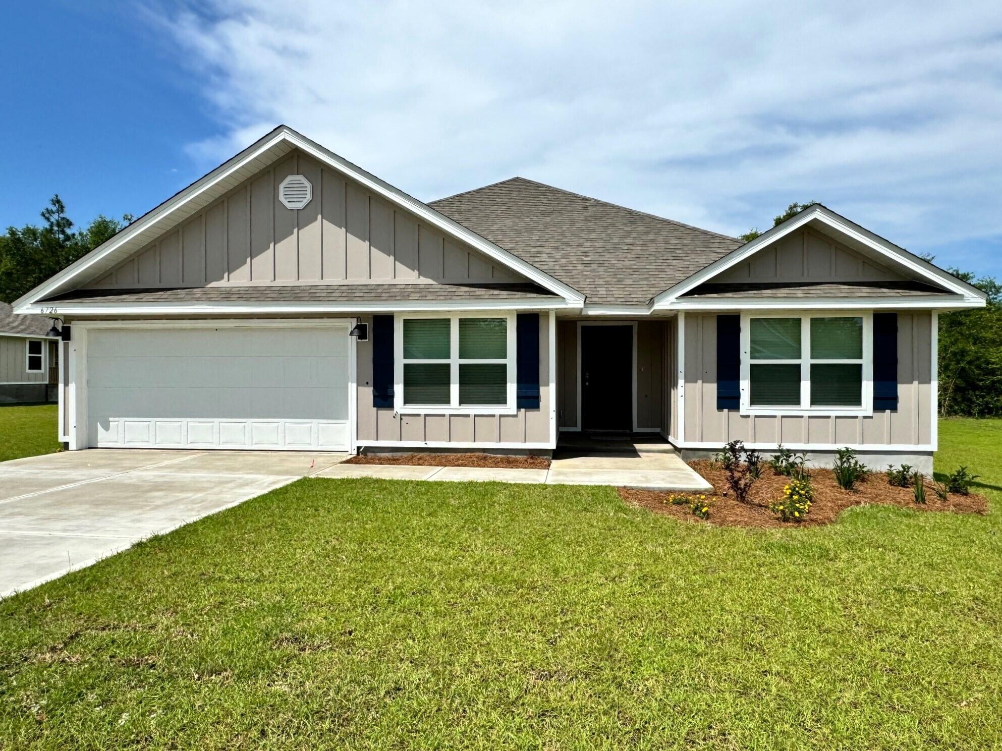 a front view of a house with a yard and outdoor seating