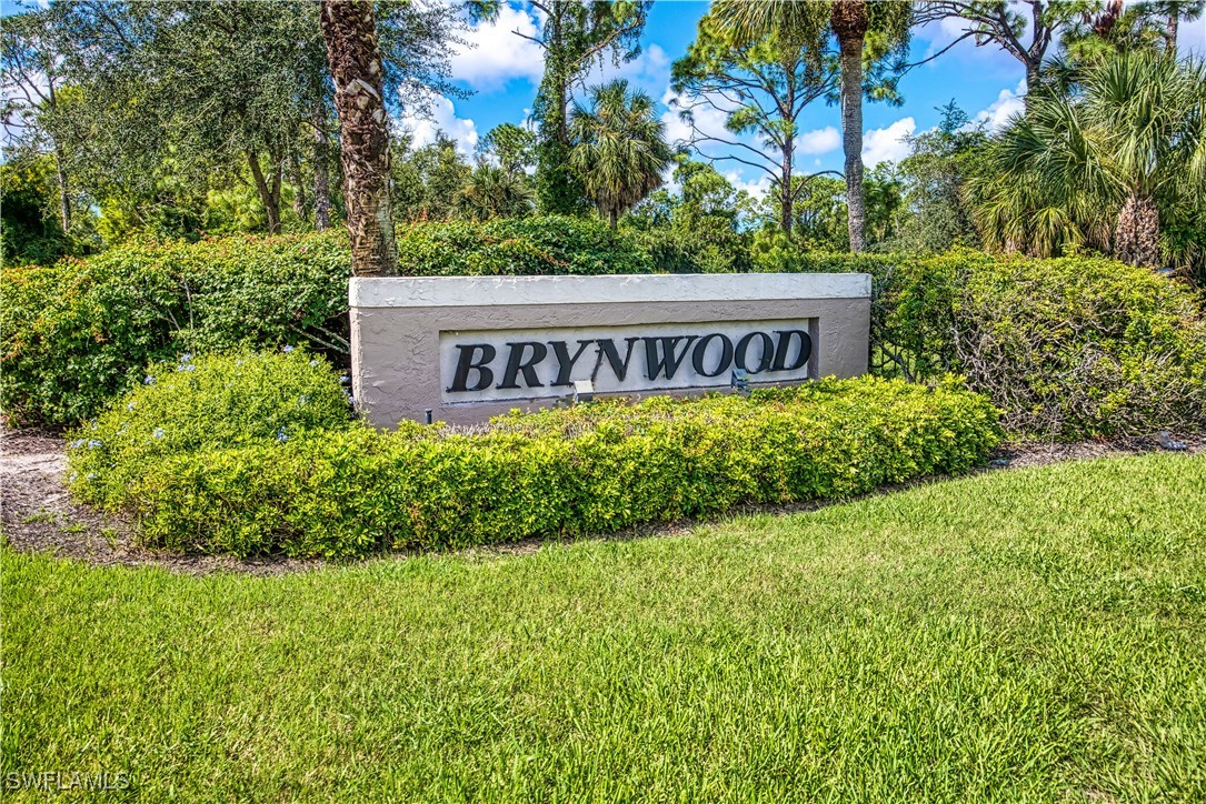 a sign that is sitting in front of flowers