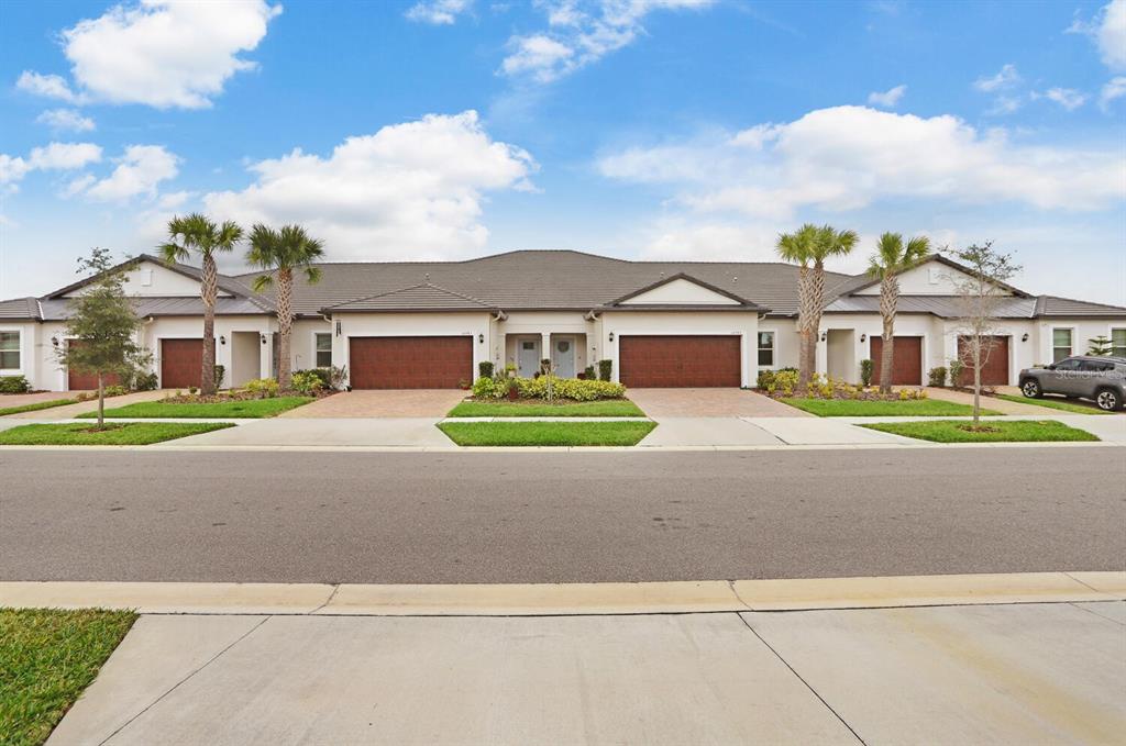 a front view of a house with a garden and yard