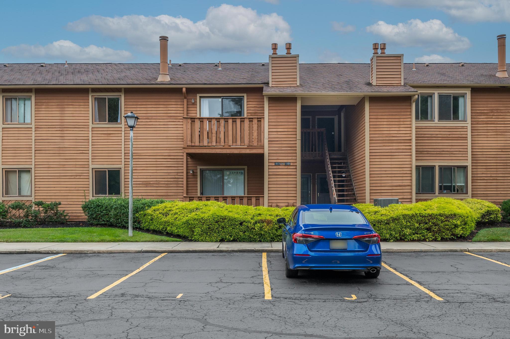 a car parked in front of a brick house