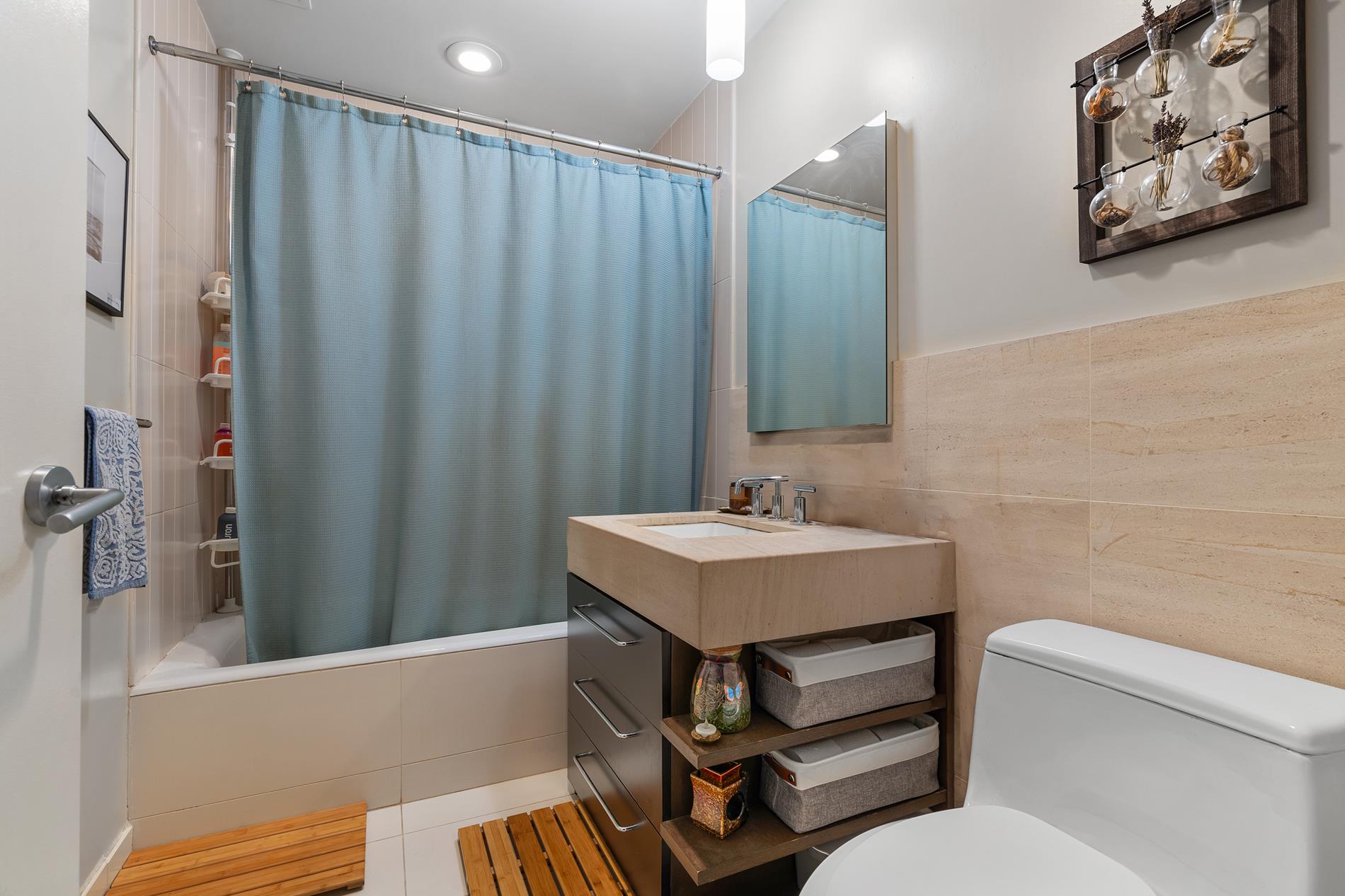 a bathroom with a sink toilet and shower