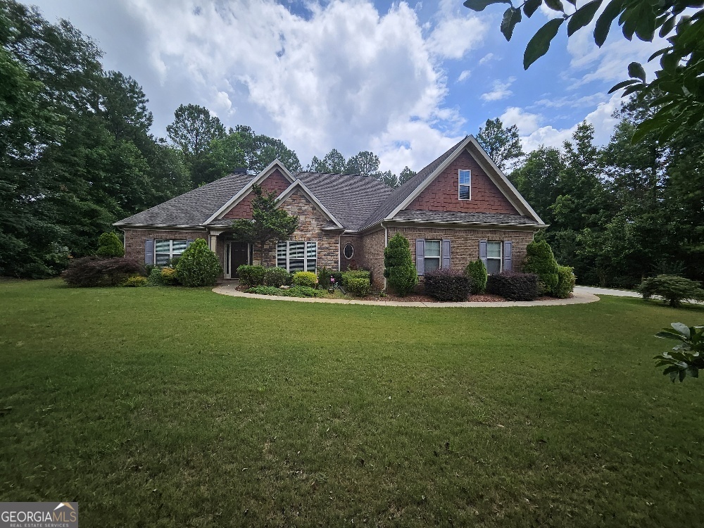 a front view of a house with garden