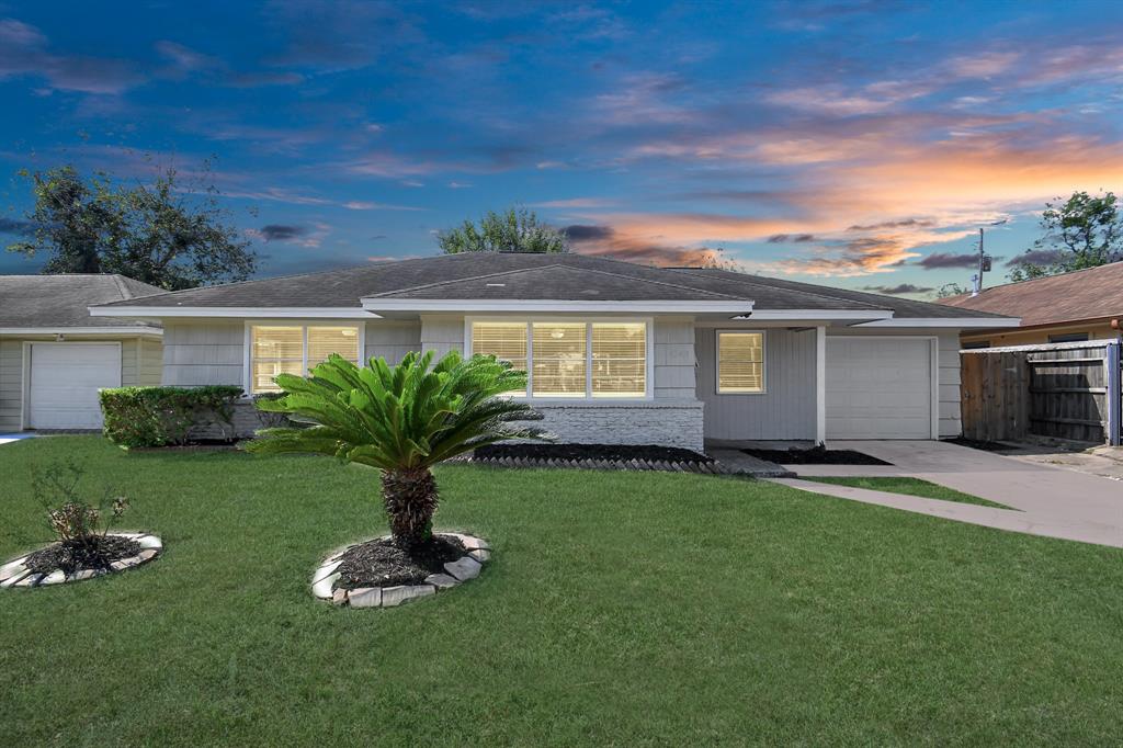 a front view of a house with a garden