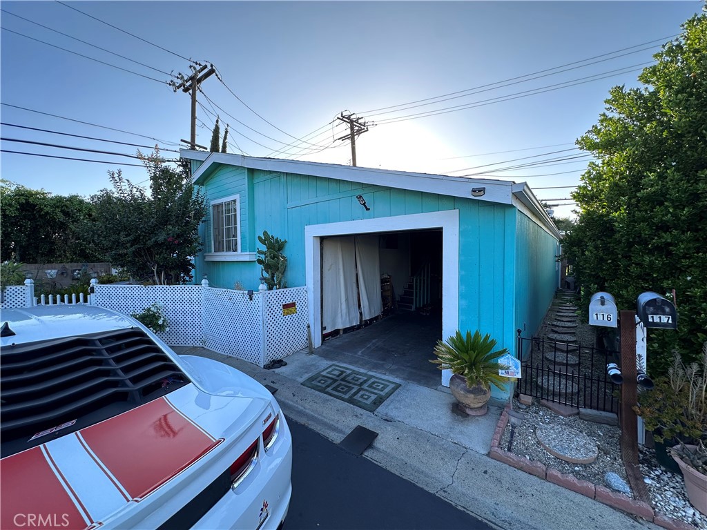 a front view of house with yard potted plant and outdoor seating