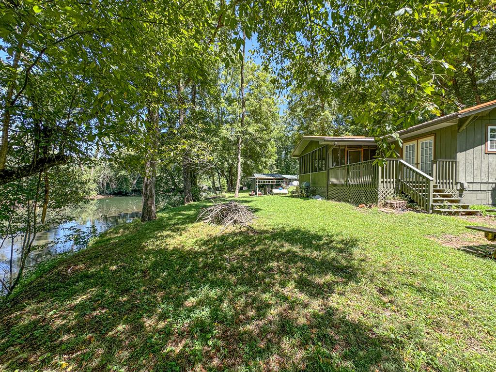 a view of house with backyard