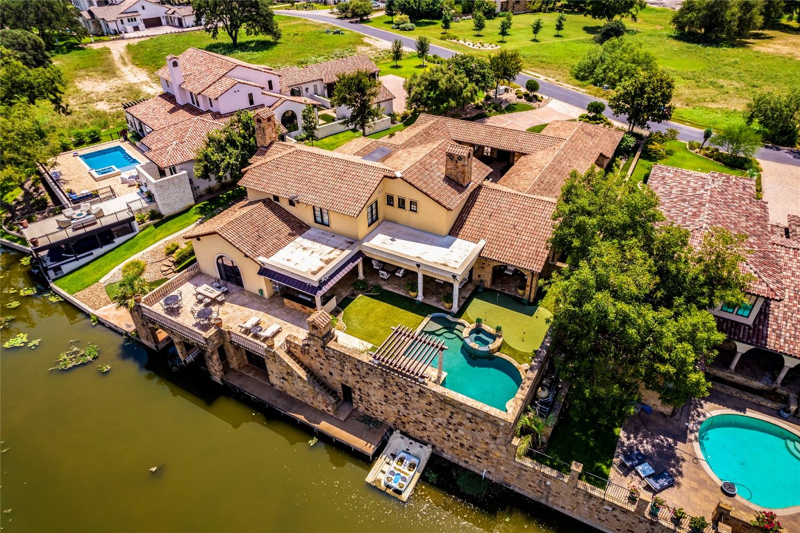 an aerial view of a house with a swimming pool yard and outdoor seating