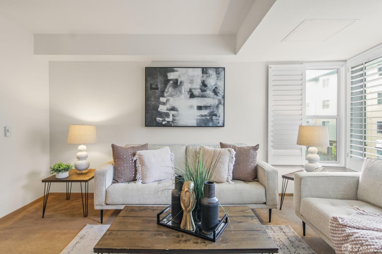 a living room with furniture and a potted plant