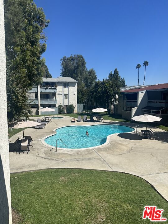 a view of a house with swimming pool and yard