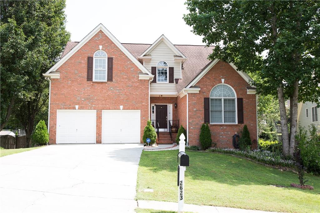 a front view of a house with a yard