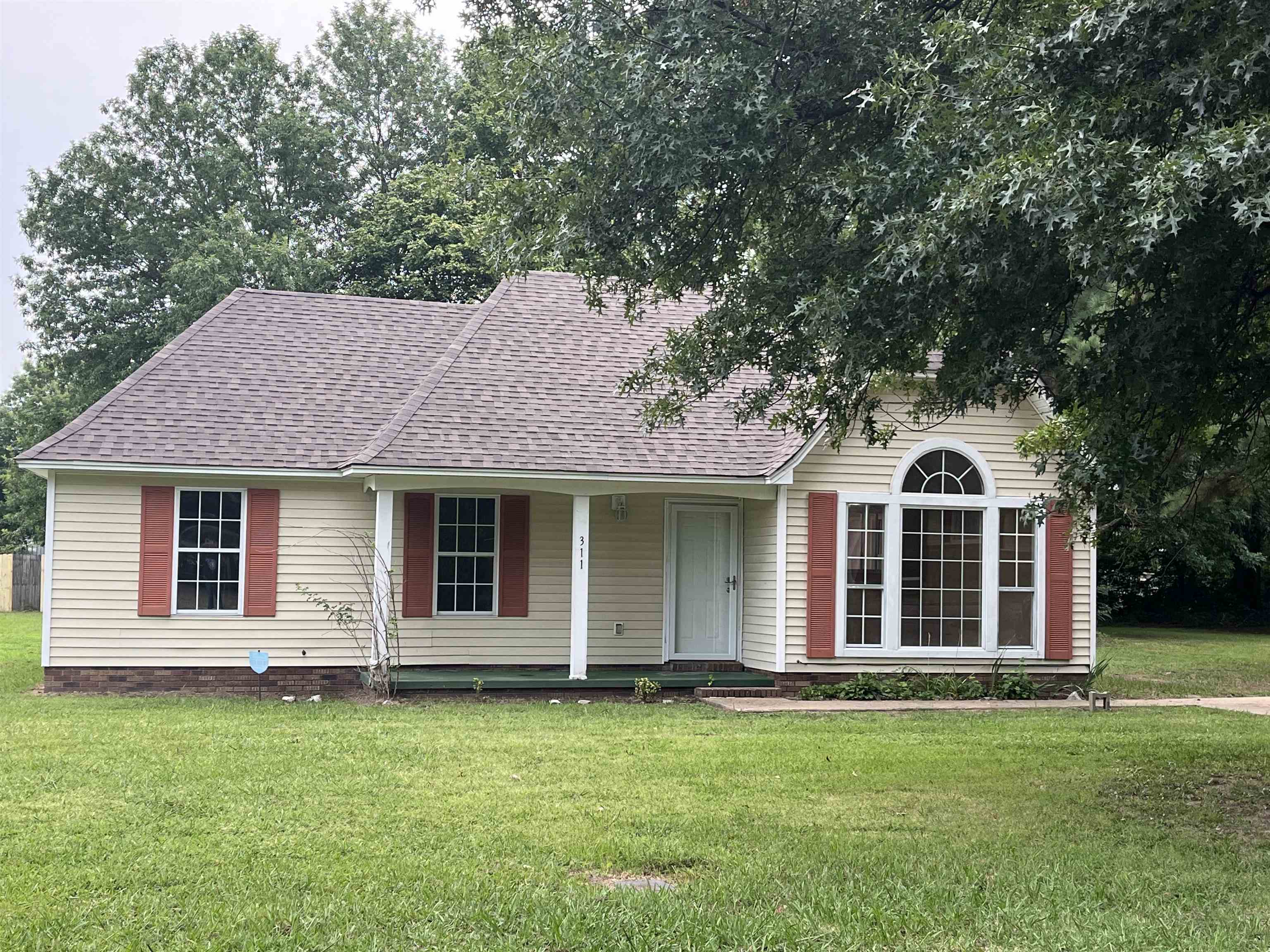 a front view of a house with a garden