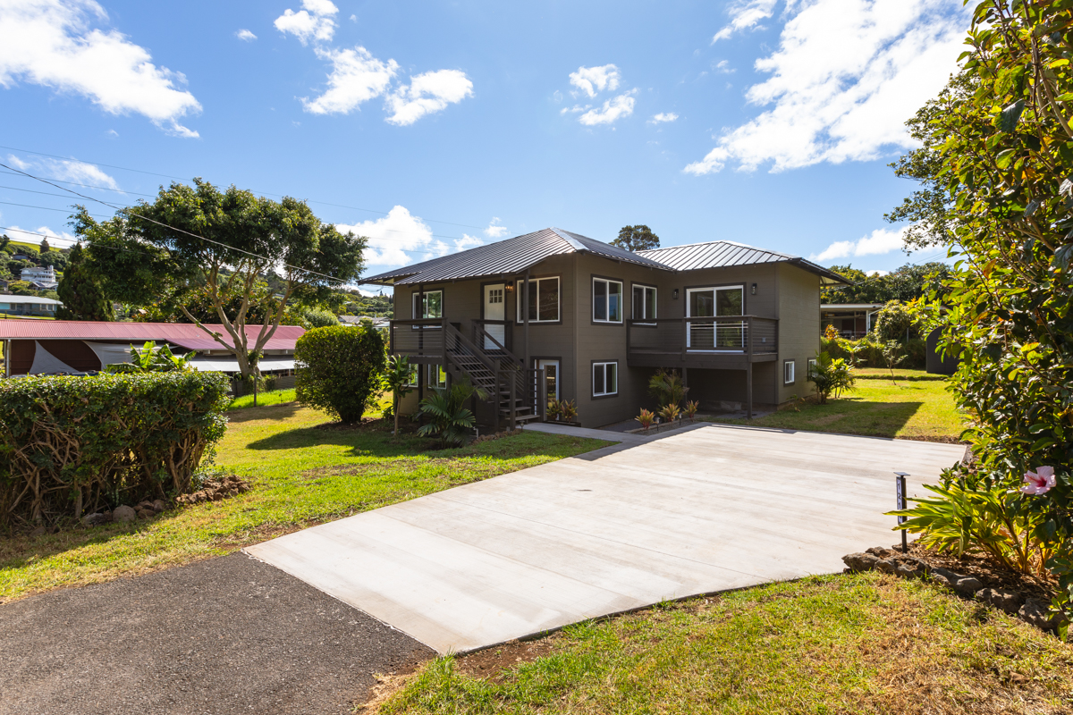 a view of a house with a yard and garden