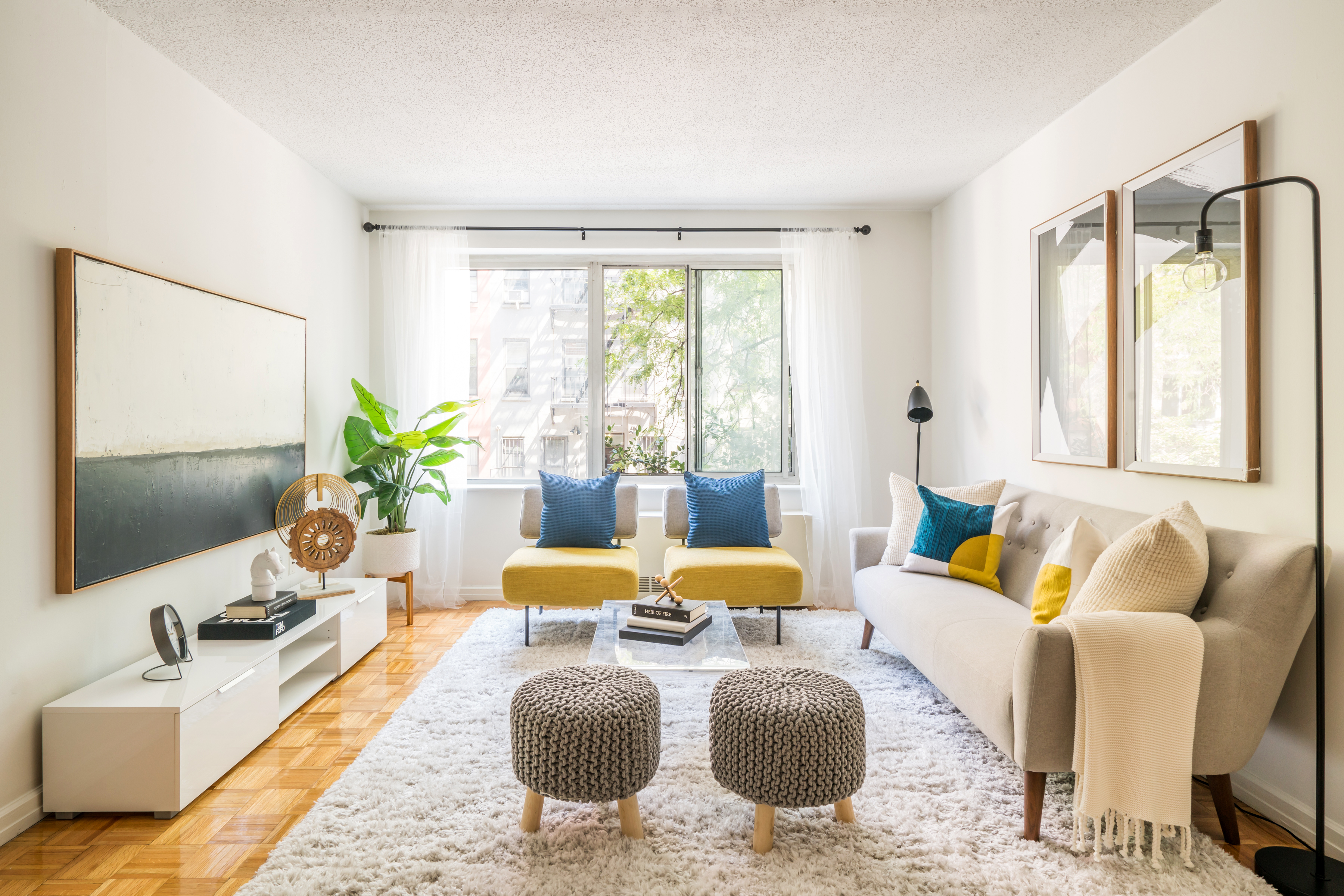 a living room with furniture and a large window