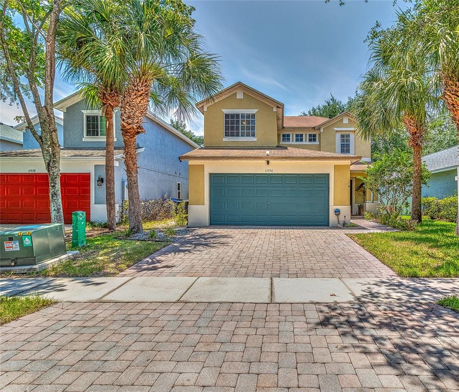 a front view of a house with a yard and a garage