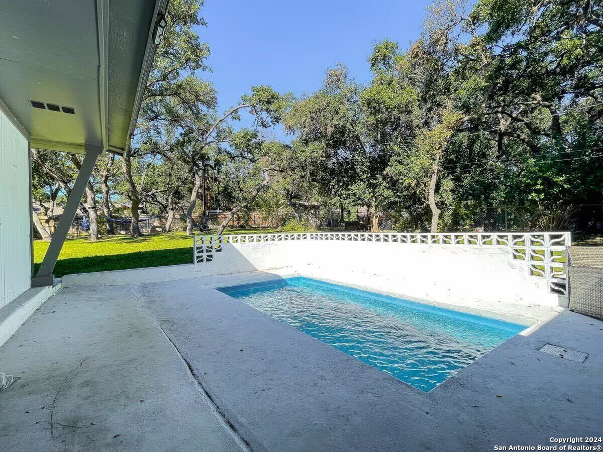 a view of swimming pool with a yard