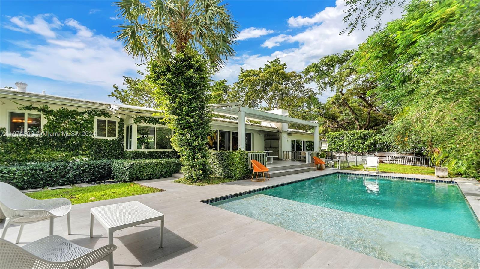 a view of a house with swimming pool and porch with furniture