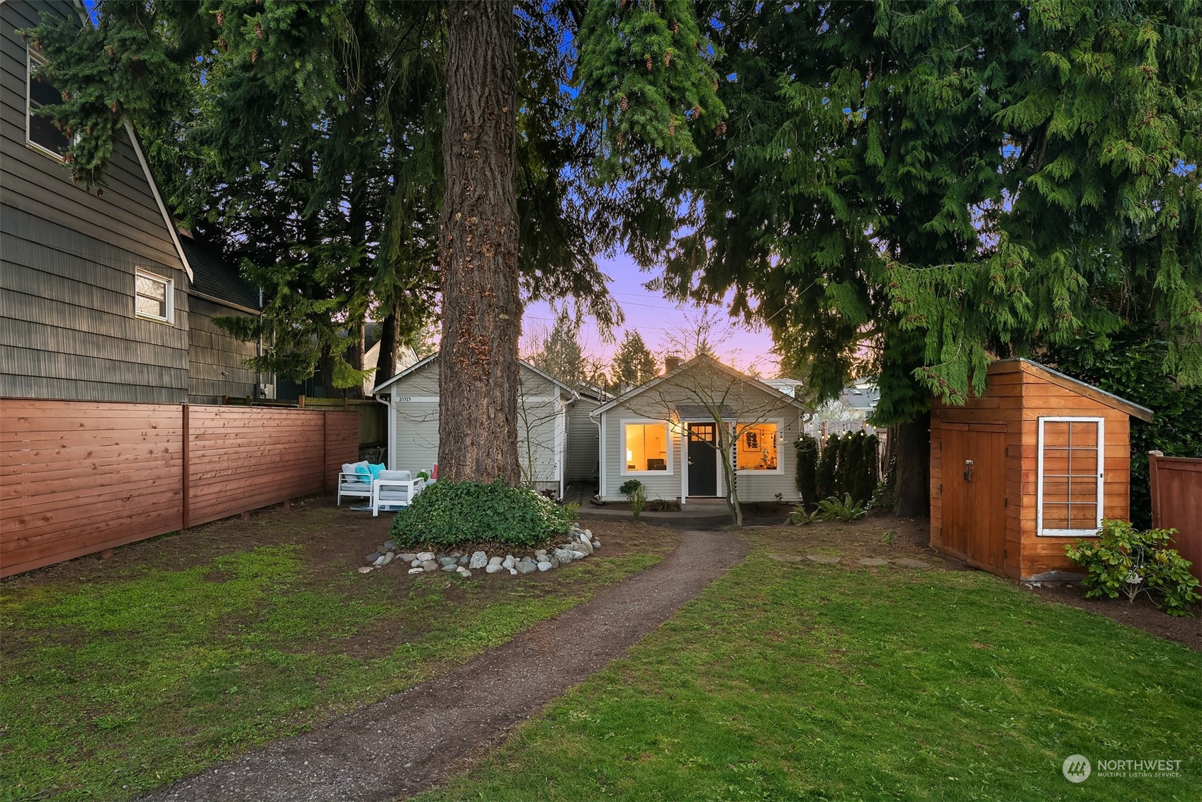 a front view of a house with a garden and yard