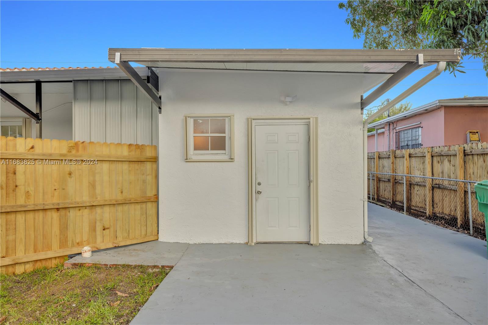 a view of a house with a wooden fence