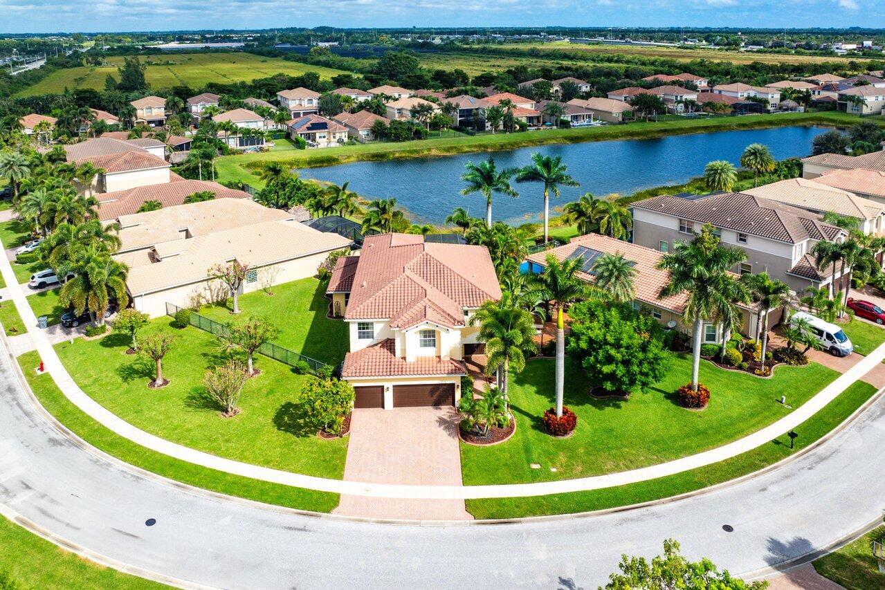 an aerial view of a house with a garden and lake view