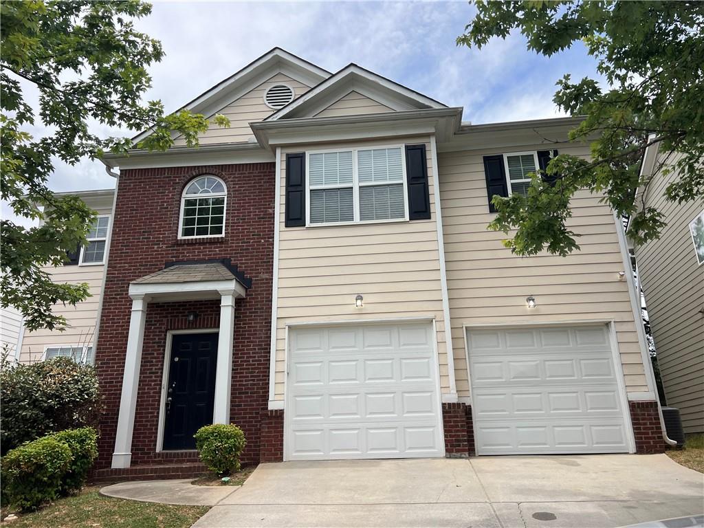 a front view of a house with garage