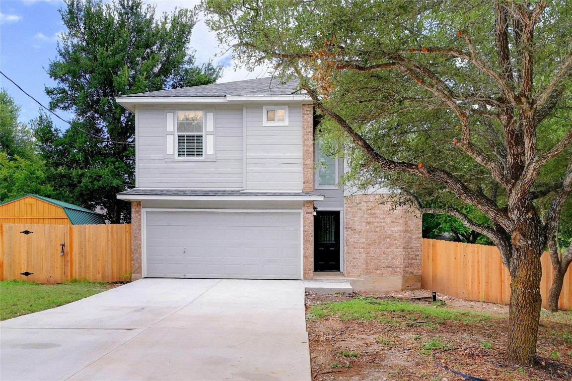 a front view of house with yard and trees