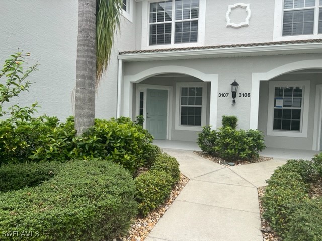 a view of a house with potted plants