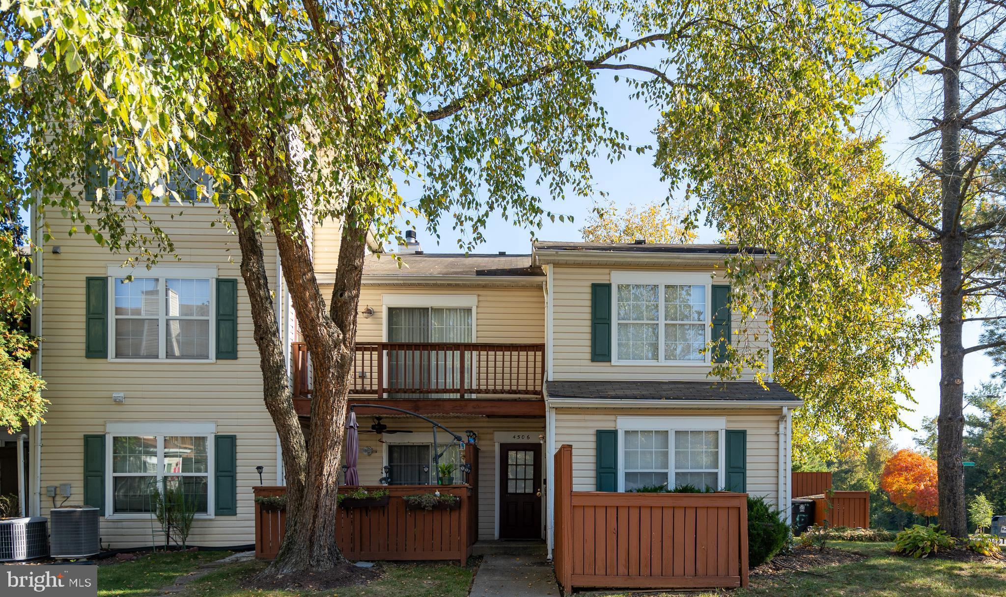 front view of a house with a tree