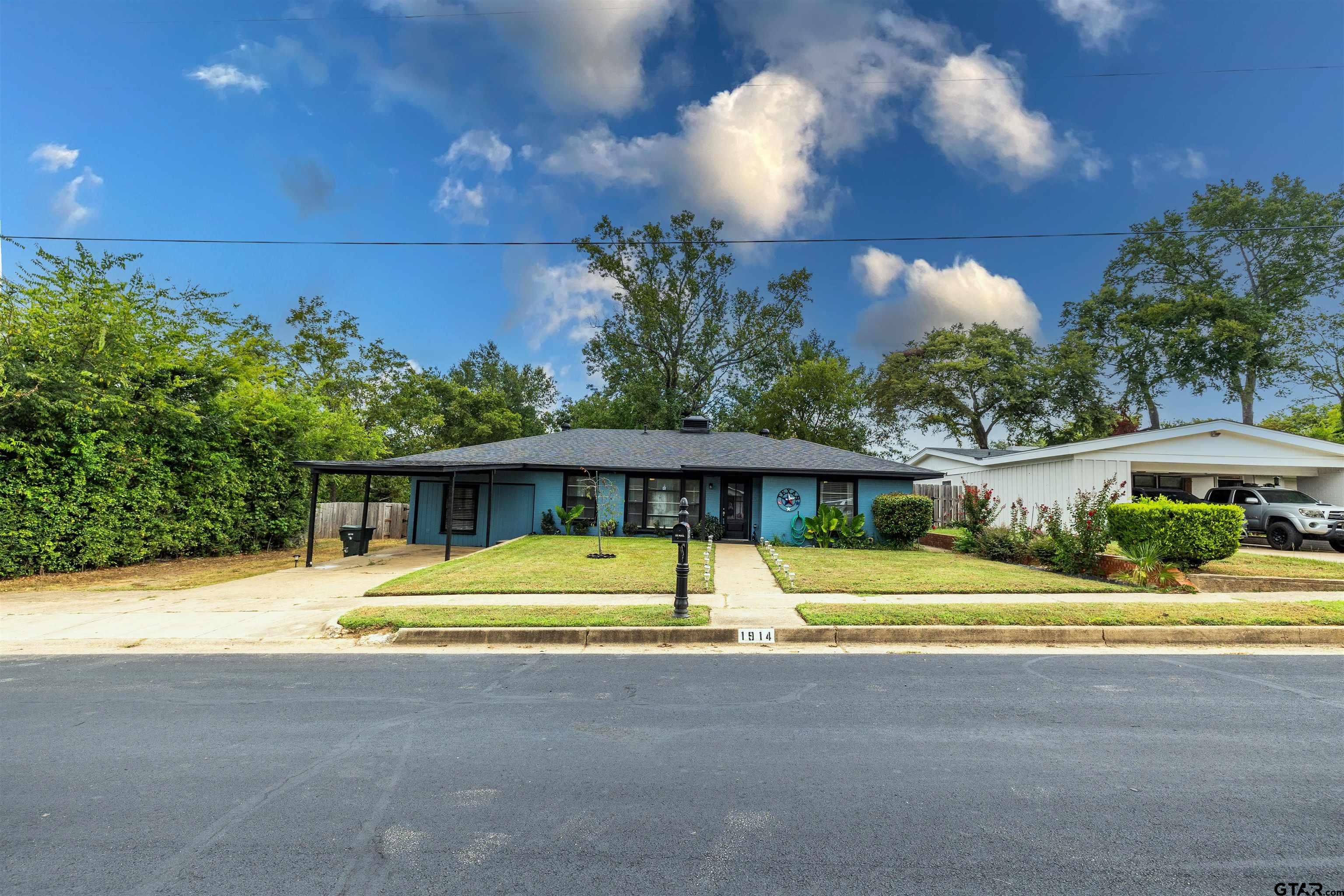 a front view of house with yard and green space