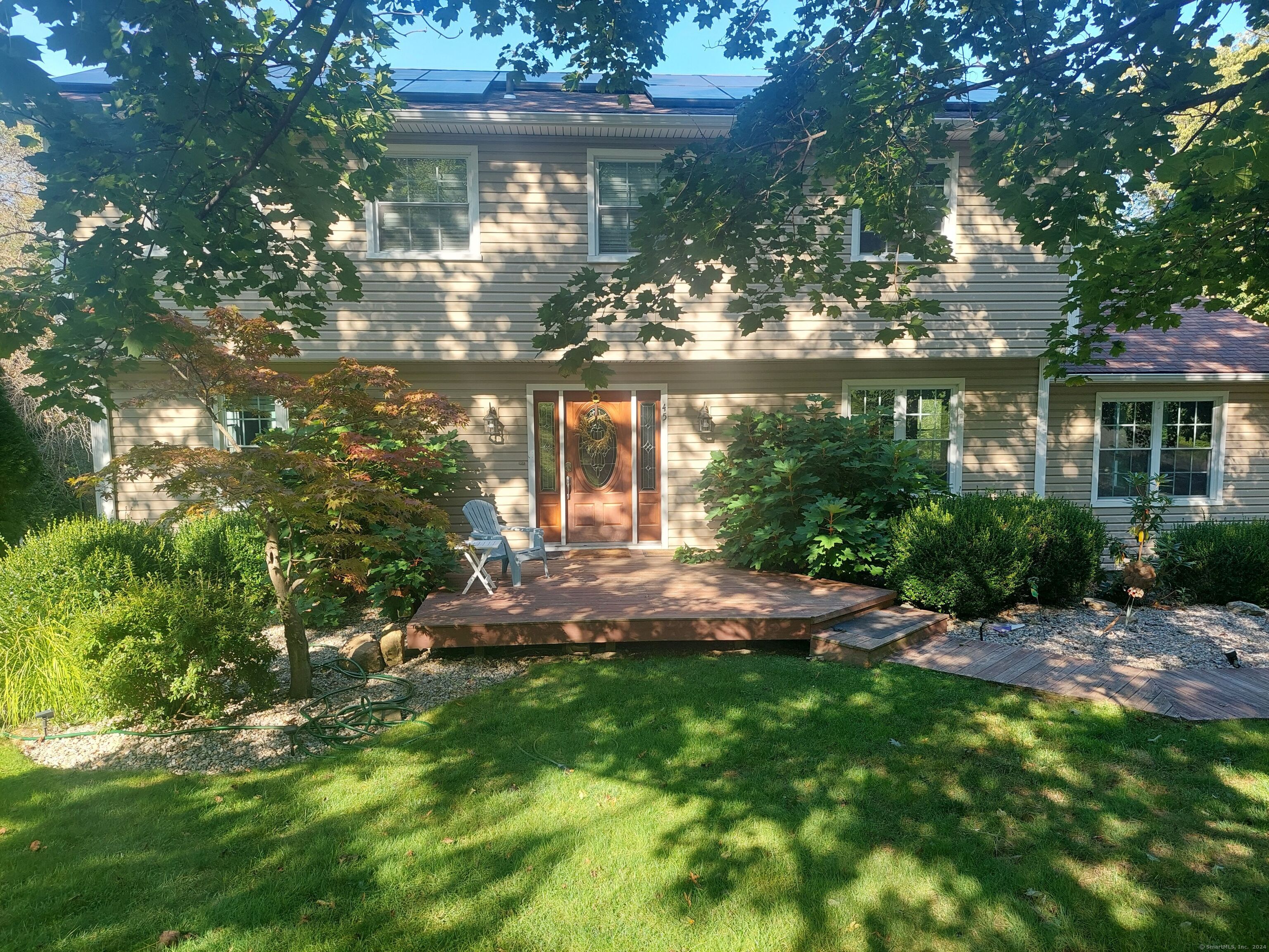 a backyard of a house with yard and outdoor seating