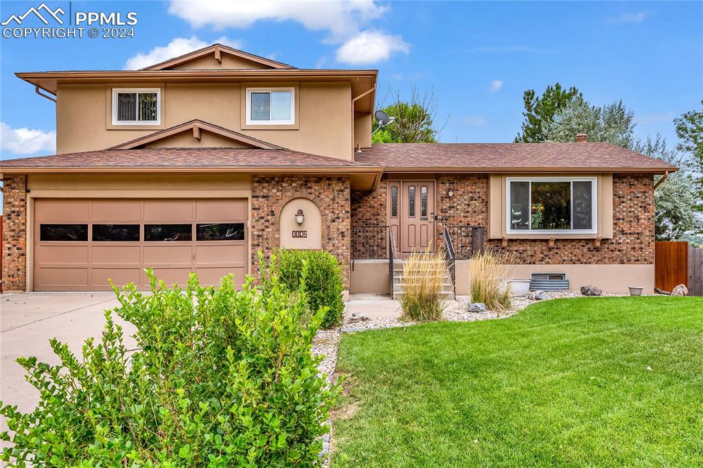 a front view of a house with a yard