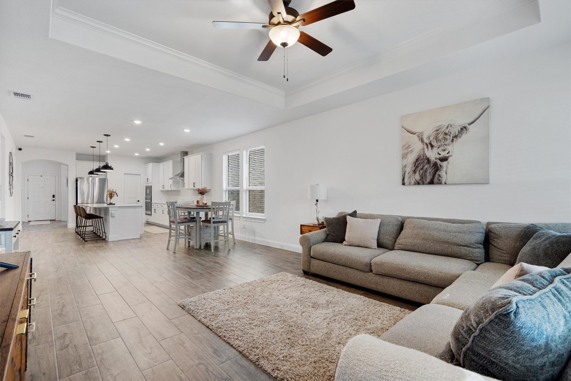 a living room with furniture and kitchen view