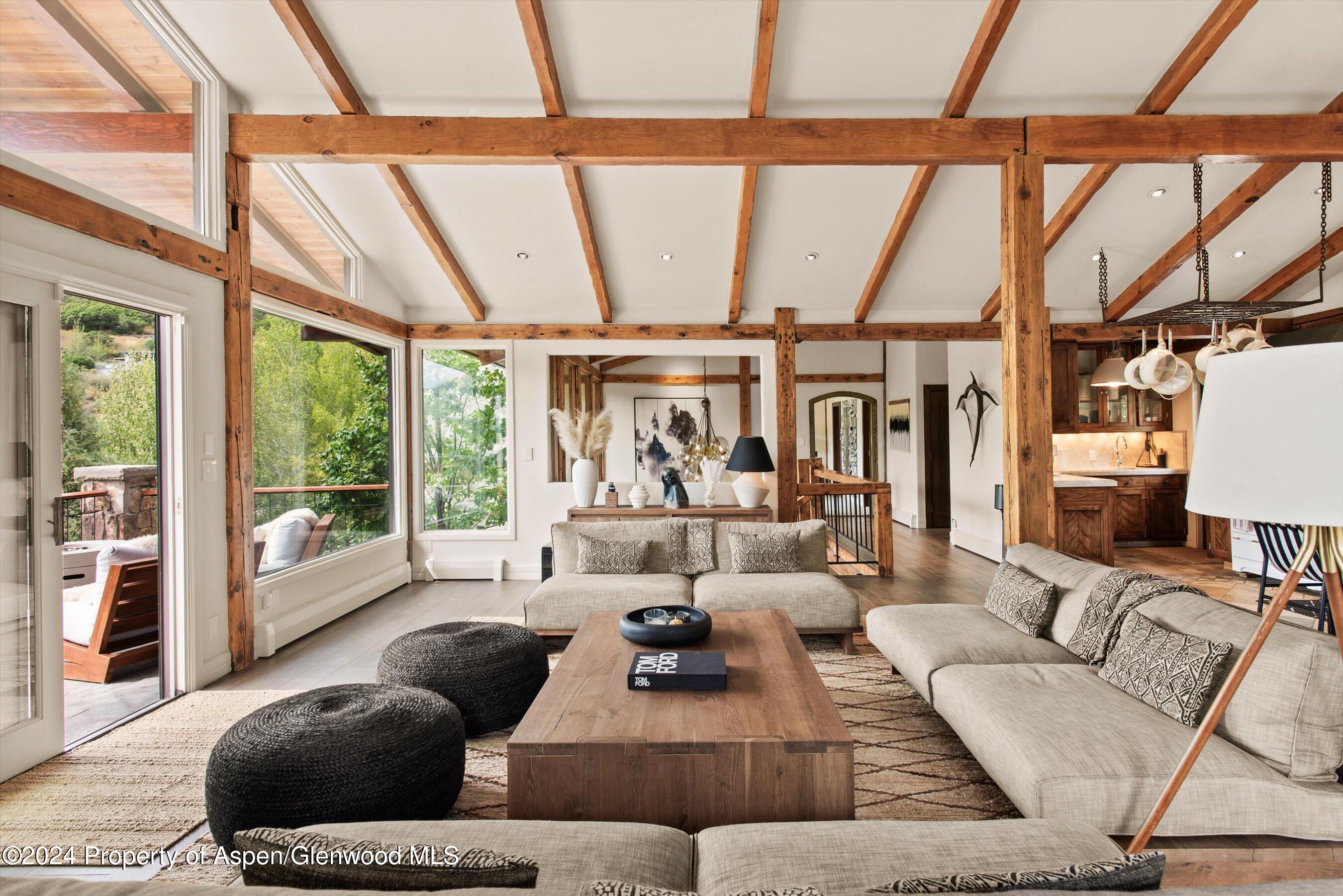 a living room with furniture and large windows