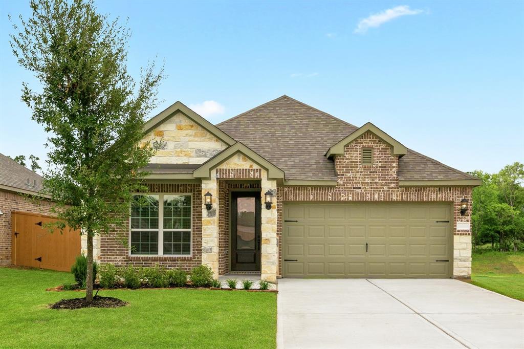 a front view of a house with a garden and yard