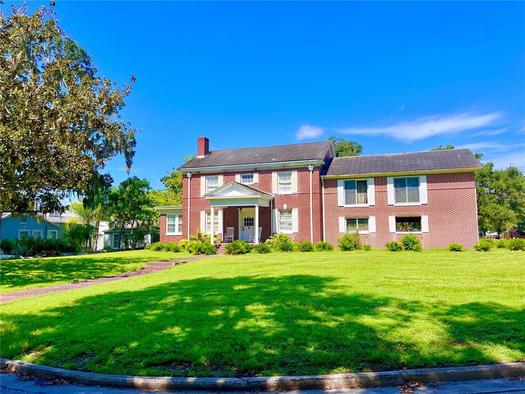 a front view of a house with a garden