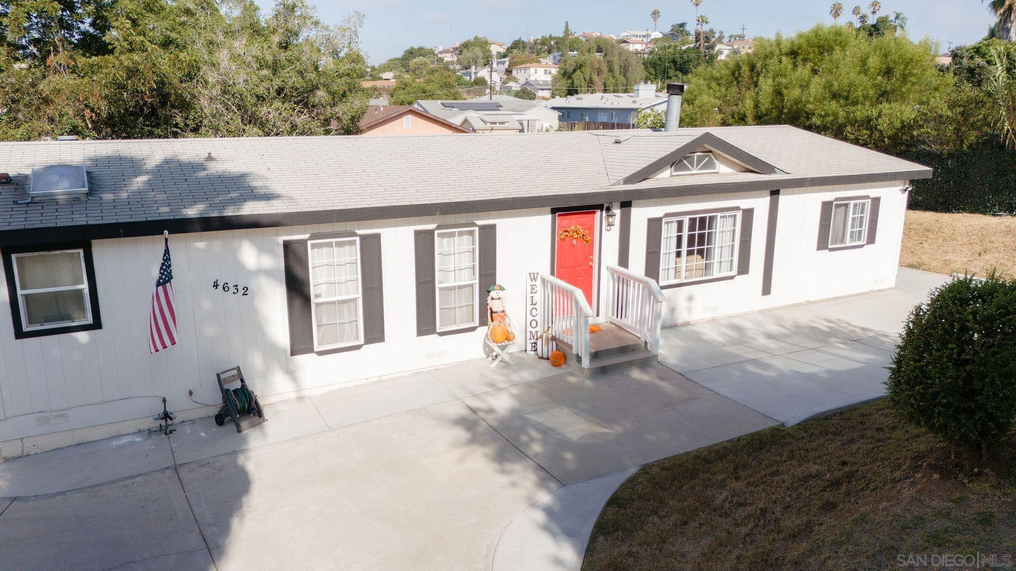 a aerial view of a house with a yard and garage