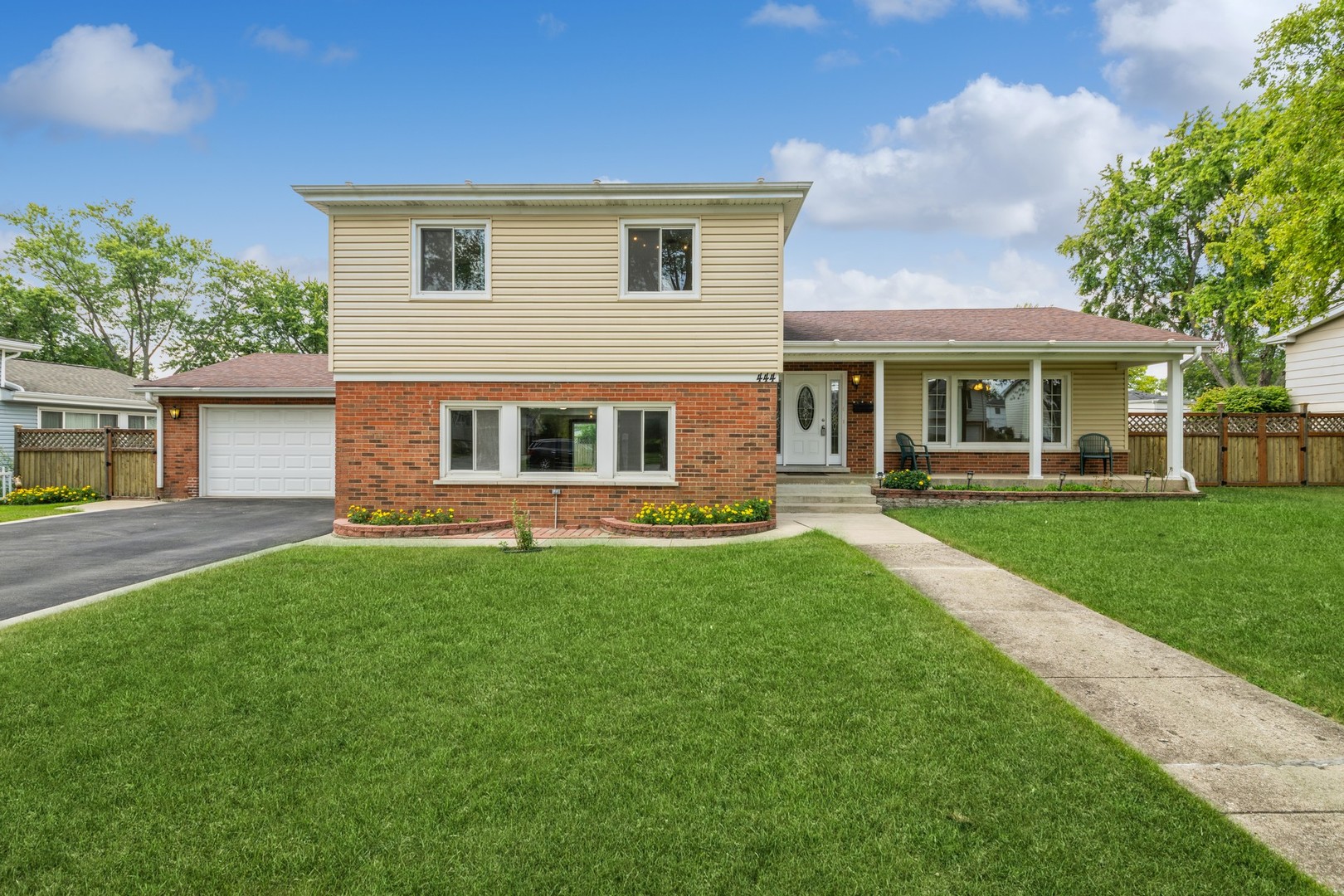 a front view of house with yard and green space