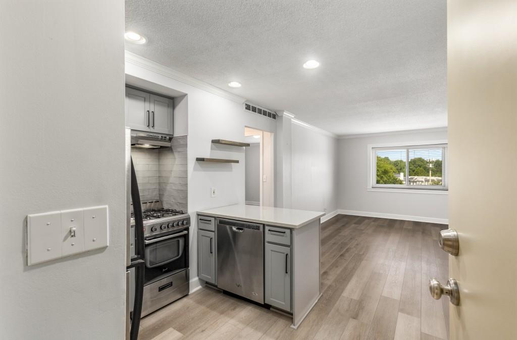 a kitchen with stainless steel appliances a refrigerator and a stove