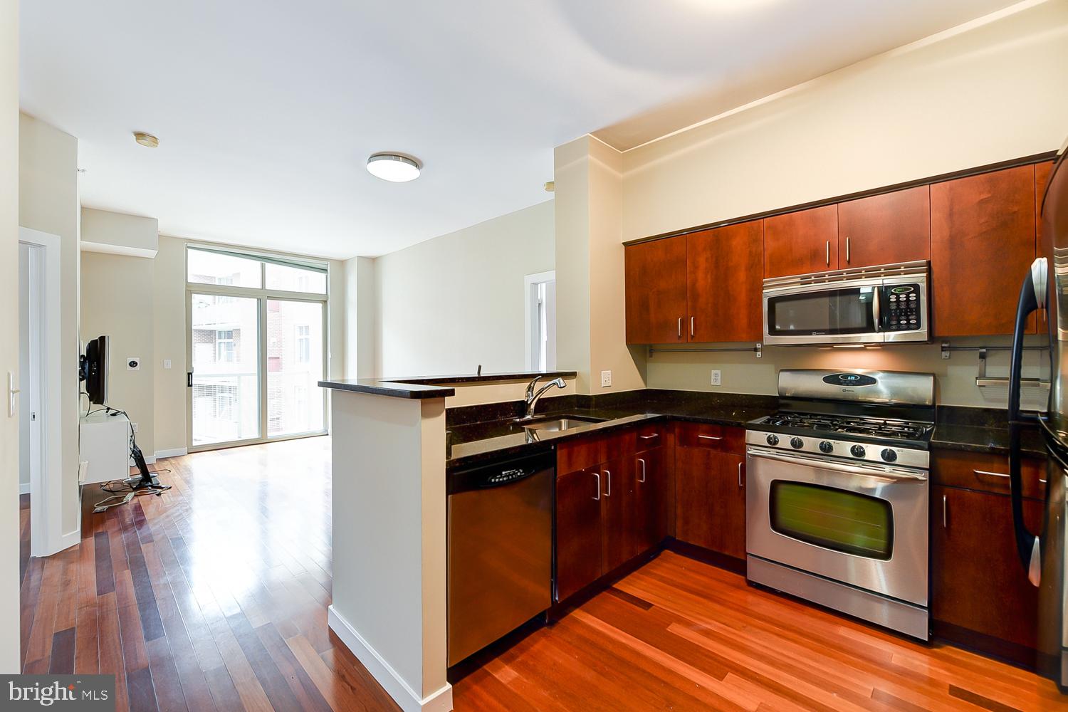 a kitchen with stainless steel appliances a stove a sink and a microwave