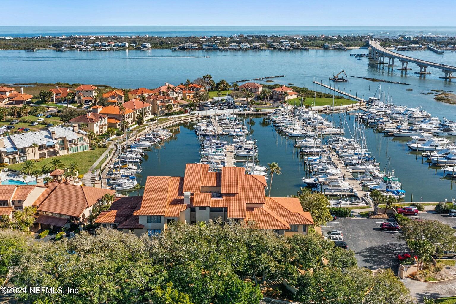 an aerial view of residential houses with outdoor space and lake view