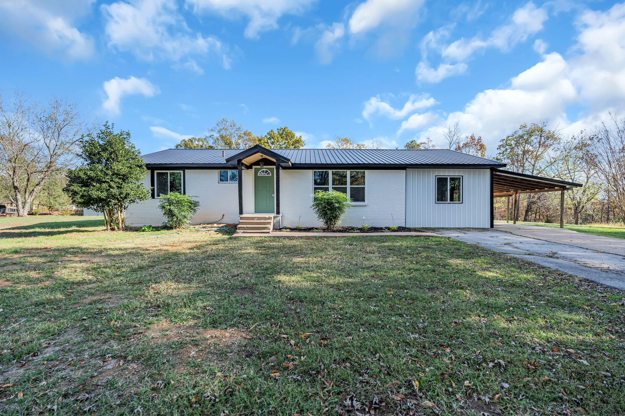 a front view of house with yard and green space