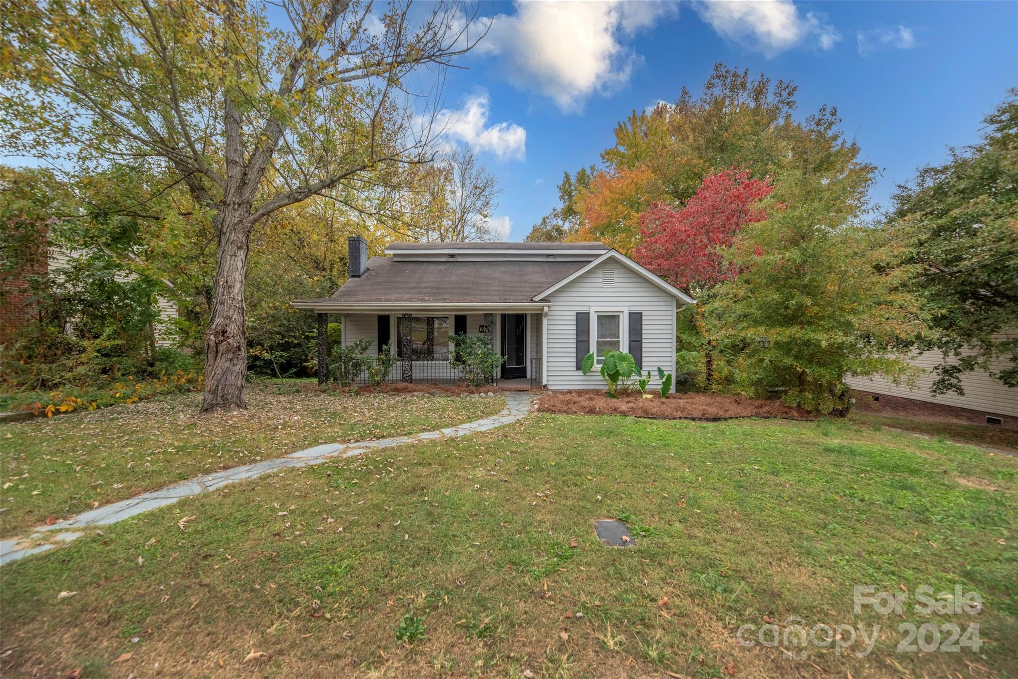 a front view of a house with yard porch and green space