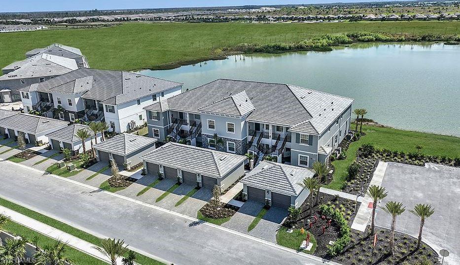 an aerial view of a house with a garden and lake view