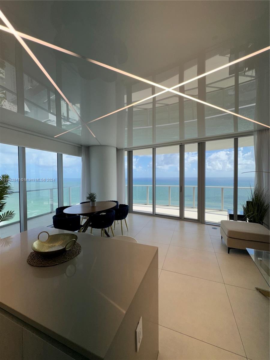 a living room with furniture and large windows