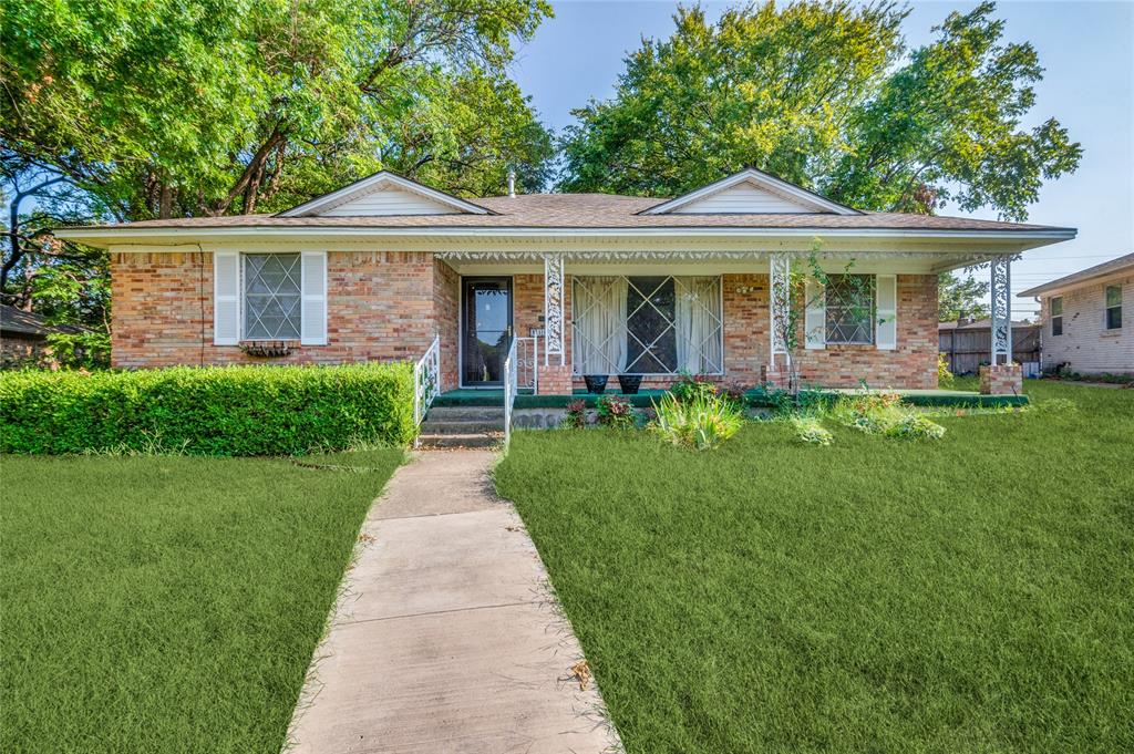 a front view of a house with a yard garden and patio