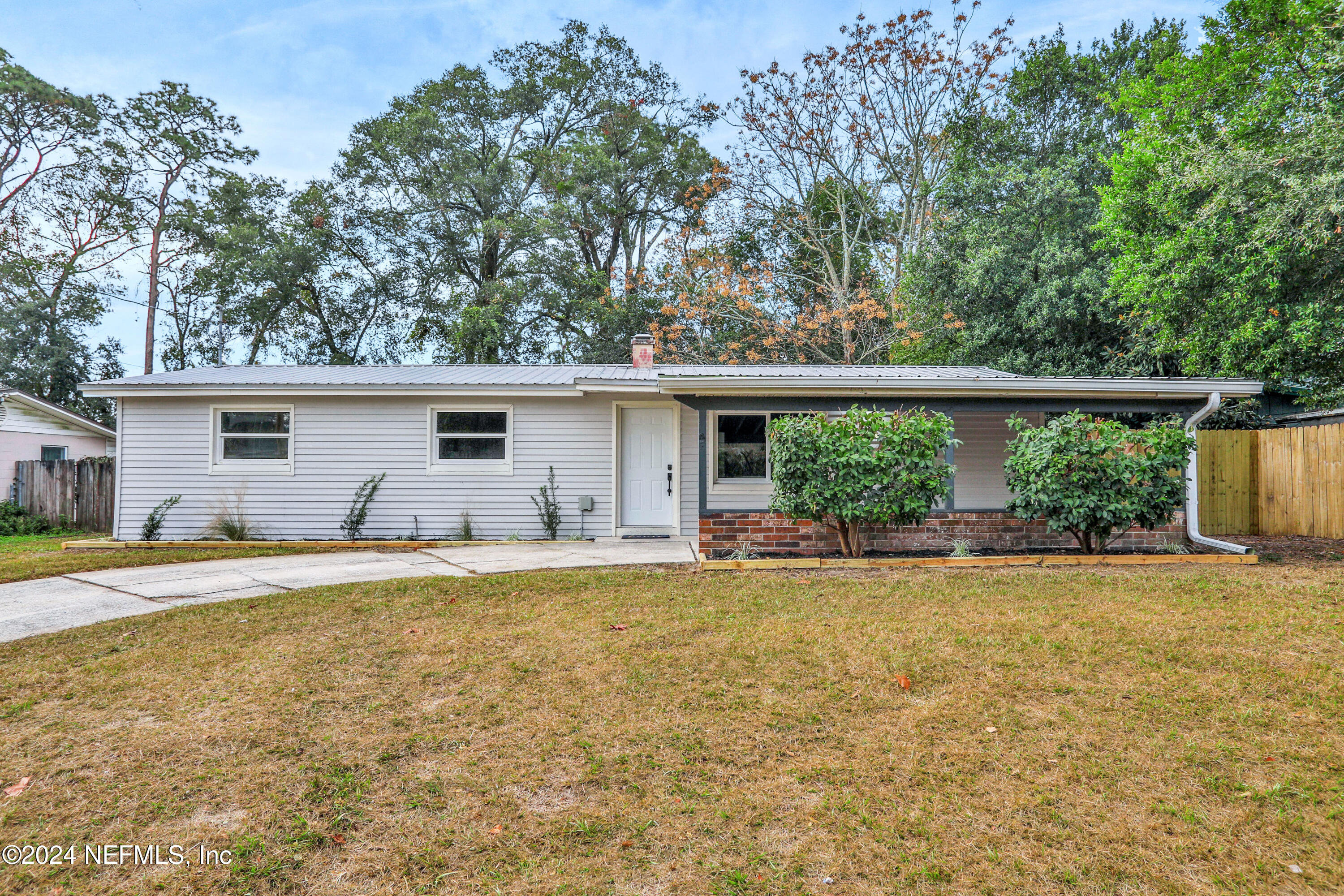 a view of a house with a backyard and a patio