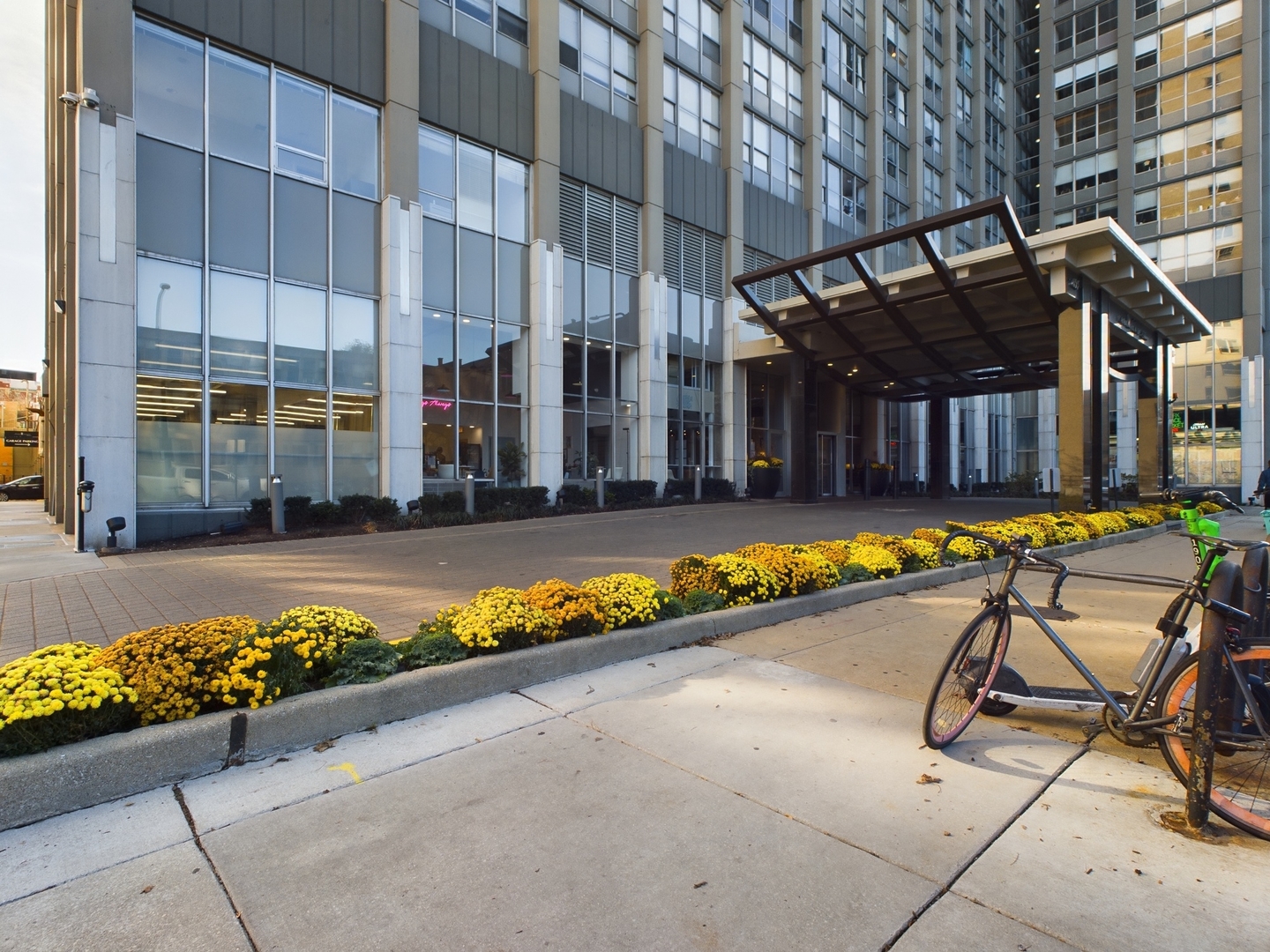 a view of a swimming pool with a lounge chair in front of a building